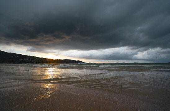 Dramatic Sea Shore Under a Moody Sky During Sunset