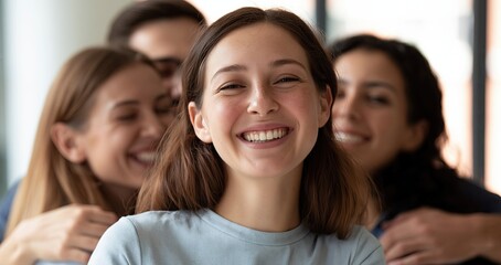 Obraz premium Bright modern office scene showing coworkers warmly embracing and smiling to welcome a new team member.