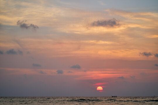 A breathtaking sunset scene with gentle ocean waves under a warm-toned sky, evoking serenity and beauty.