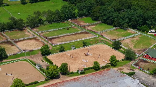 Aerial view of an equestrian facility with horse riding arenas and paddocks on Long Island, New York, United States.