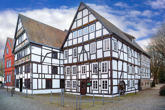 Street with half timbered houses in Paderborn, Germany, street level view. Winter historic town under cloudy sky without snow