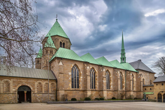 Essen Minster in Germany, side view. Historic gothic and romanesque church architecture under cloudy winter sky without snow