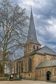St Johann Baptist Church in Essen, Germany, side view. Historic gothic and baroque architecture under cloudy winter sky without snow