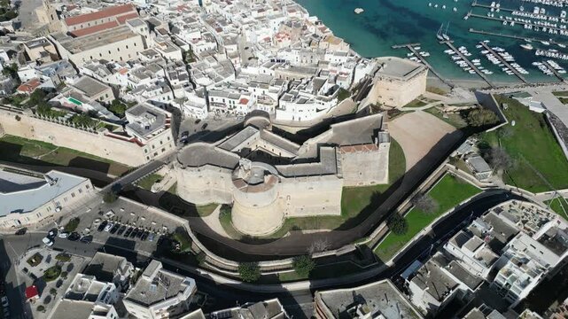 Aerial view of the historic Castello Aragonese fortress surrounded by the old town and harbor in Otranto, Apulia, Italy.