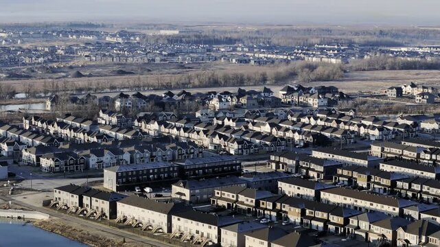 Aerial view of Barrhaven suburban housing development in Ottawa during early winter morning light. g.
