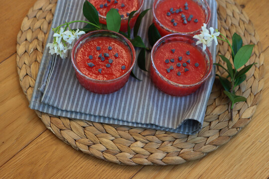 Traditional Sicilian Watermelon Puddings called Gelo di Mellone with chocolate chips  in glass bowls on wooden table with jasmin flowers