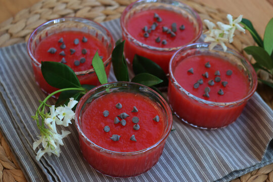 Traditional Sicilian Watermelon Puddings called Gelo di Mellone with chocolate chips  in glass bowls on wooden table with jasmin flowers
