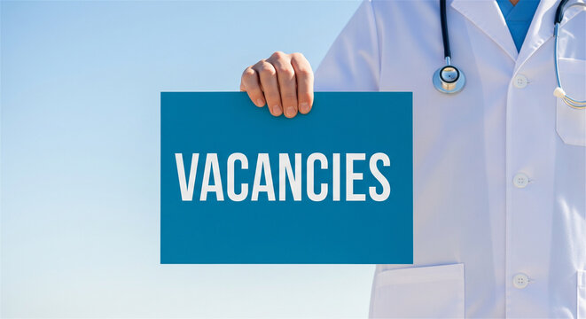 Medical vacancies sign held by doctor, healthcare recruitment concept, hospital hiring and employment banner