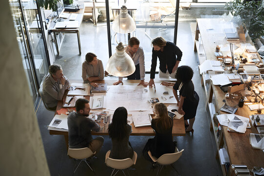 For innovative architectural projects, architects collaborate in planning and design sessions held in a modern office space