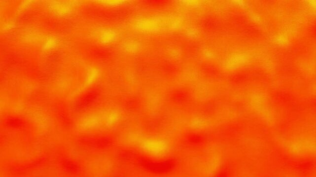 Warm abstract motion background with evolving orange red yellow texture and localized brightening across wide horizontal space, creating soft glowing blends and dynamic visual energy