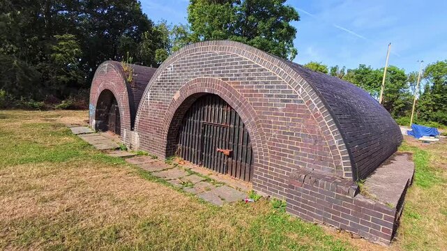 Restored brick pyrites kilns on Spike Island nature park in Widnes closeup left dolly shot
