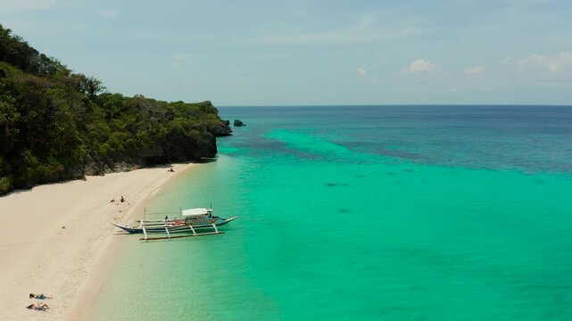 Travel concept: sand beach with tourists and turquoise water on Boracay, Philippines, aerial drone. Seascape with Puka shell beach on tropical island. Summer and travel vacation concept.