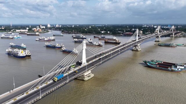 Aerial view of Karnaphuli 3rd Bridge with cargo ships and boats on the river in Chittagong, Chittagong Division, Bangladesh.