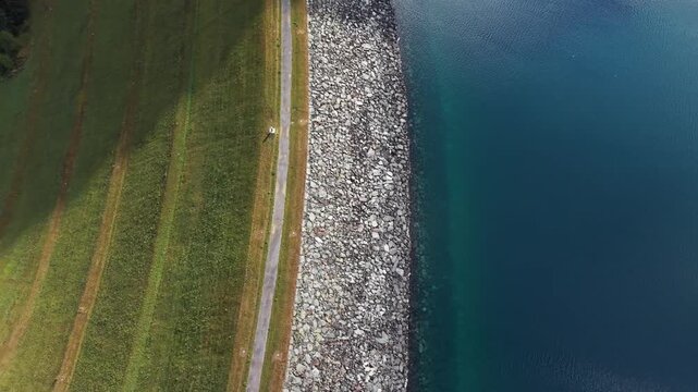 Aerial view of the Marmorera Dam embankment and reservoir water in Surses, Grisons, Switzerland.