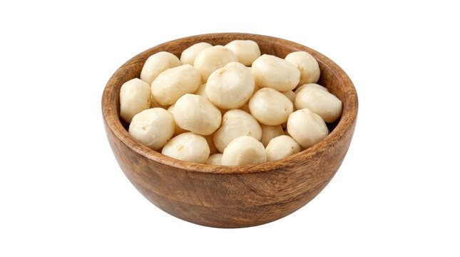 Wooden bowl filled with fresh white macadamia nuts.