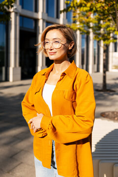 Woman smiling wearing glasses in golden hour