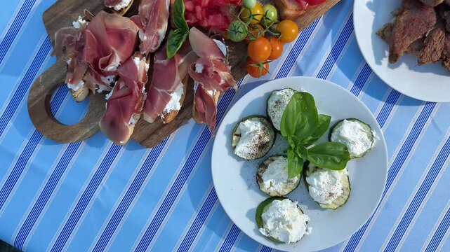 Close up overhead shot of assorted gourmet meats charcuterie board featuring salami prosciutto and cheeses for entertaining