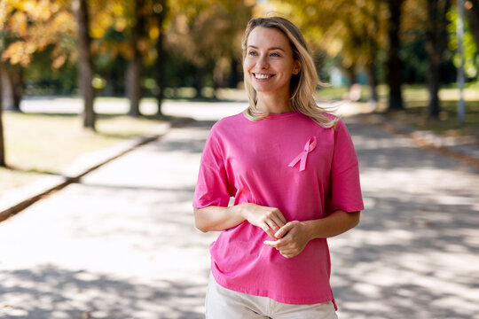 Woman wearing pink ribbon supporting breast cancer awareness