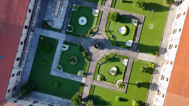 Aerial view of the symmetrical geometric gardens and central fountain of a historic building in Allariz, Province of Ourense, Spain.