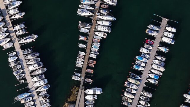 Aerial view of numerous sailboats and motorboats neatly arranged in rows at the marina in Skarhamn, Vastra Gotaland County, Sweden.
