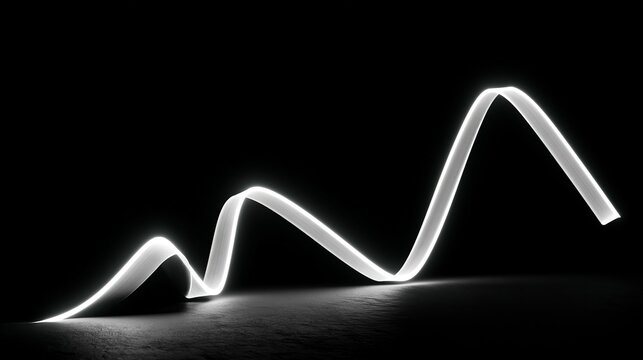 Bright luminous trail arcs gracefully across a stark black surface, creating an abstract light painting perfect for representing energy or a visual rhythm