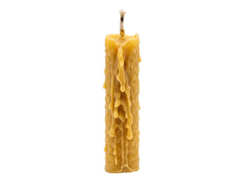 Beeswax candle with dripping wax isolated on black background studio shot, natural unlit yellow wax pillar candle, traditional handmade craft object for spa wellness relaxation and peaceful atmosphere