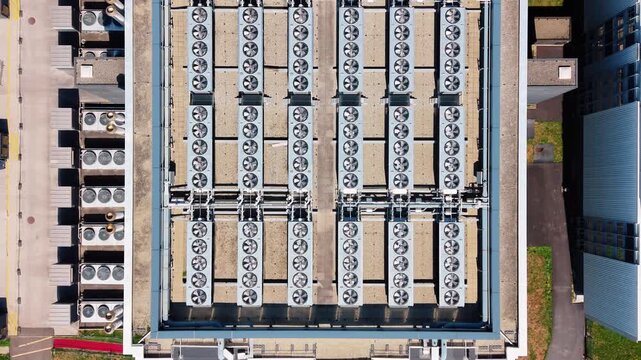 Aerial view of the STACK Infrastructure GEN02A Data Center rooftop featuring rows of industrial cooling fans and HVAC units in Gland, Vaud, Switzerland.