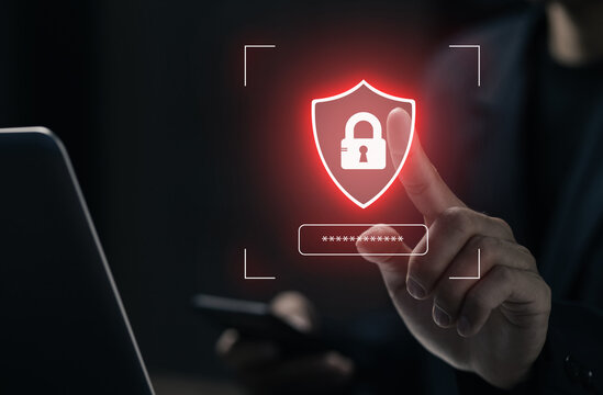 Business user activates digital security shield and password protection on laptop, representing cybersecurity, secure access, data privacy, authentication, and online protection.