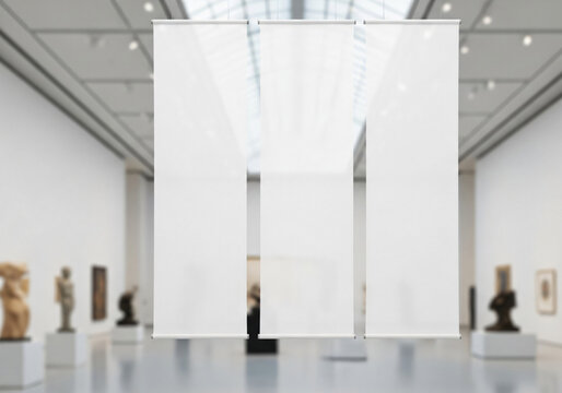 Three Blank Vertical Banners Hanging in a Blurred Art Gallery Interior