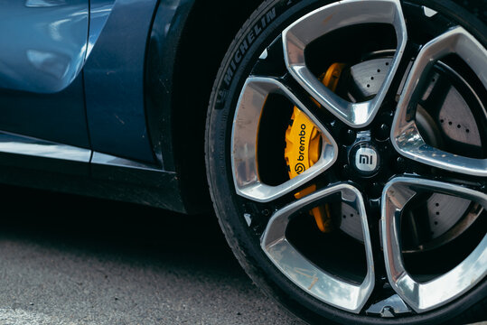 Smolensk, Russia 08.08.2026 Xiaomi SU7 A close-up view of a car wheel highlights the shiny alloy rims and yellow brake calipers.