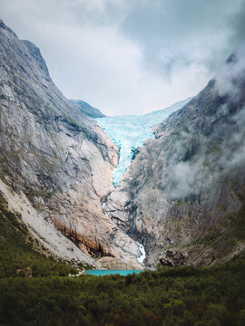 Briksdalsbreen glacier in Norway moody landscape lake in mountains and forest scenic view, travel in Stryn summer season nature scenery beautiful destinations in Scandinavia