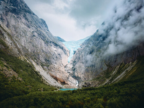 Briksdalsbreen glacier with lake in mountains and forest landscape in Norway breathtaking scenery, explore Stryn summer season scenic nature travel beautiful destinations in Scandinavia