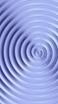 Rotating Metallic Spiral Texture. Macro view of silver metal rings spinning around the center in a hypnotic radial pattern.
