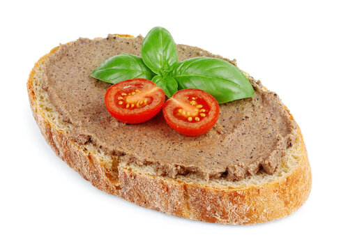 pate on a slice of bread with basil and cherry tomatoes isolated on a white background