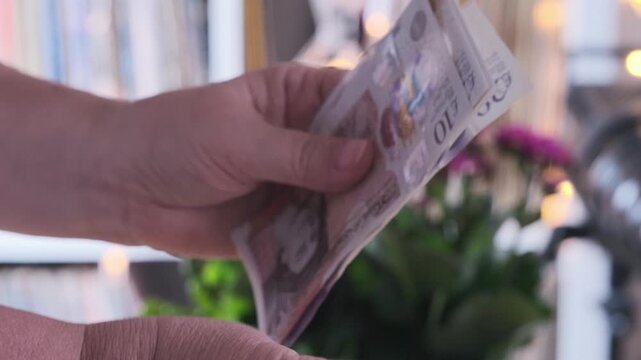 Close-up female hands counting uk pounds bills, paper money on blurred background, British GBP banknotes, Money Management Accuracy, salary, payments to fund, financial freedom, save up for vacation
