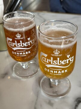 Copenhagen, Denmark, June 18th 2026:A double toast to Danish heritage: Two crisp, golden pints of iconic Carlsberg perfectly poured in the heart of Copenhagen.