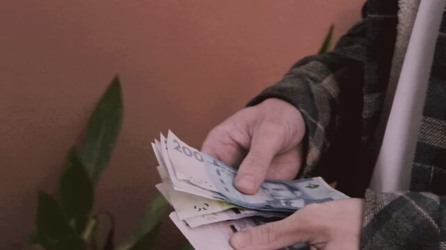 closeup male hands hold Moroccan dirham money, count paper dirham banknotes, concept cash payments, monetary savings, save for vacation, exchange and cashing currency