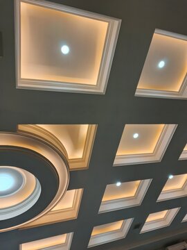 Modern false ceiling design with square recessed lighting and decorative molding details