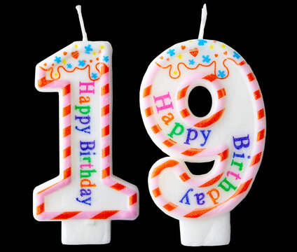 Number nineteen shaped birthday candle with colorful sprinkles and Happy Birthday text isolated on a black background