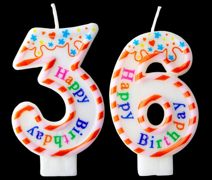 Number thirty six shaped birthday candle with colorful sprinkles and Happy Birthday text isolated on a black background