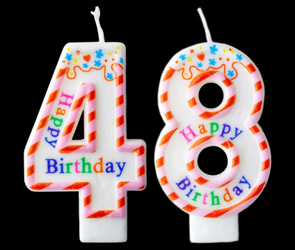 Number forty eight shaped birthday candle with colorful sprinkles and Happy Birthday text isolated on a black background