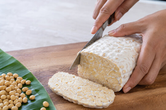 Tempeh slice on wooden cutting board