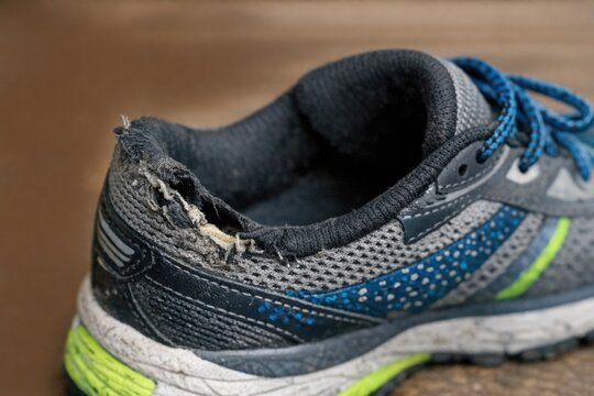 A detailed view of a pair of running shoes with laces and sole
