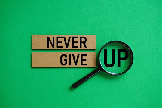 NEVER GIVE UP. Motivational quote. Self-inspiration shapes personality. Learning concept. Self-development. Encouraging words. Life-changing guide
