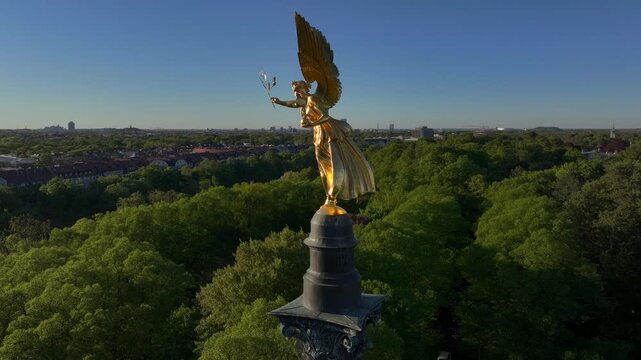 Golden Angel of Peace in Munich at sunset, Peace Memorial, Aerial Drone Shot of Friedensengel in Munchen, Germany.