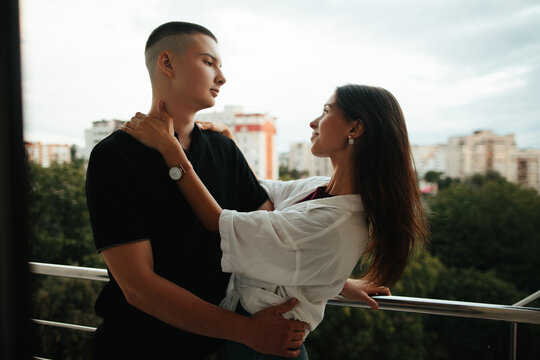 Young couple embracing on a city balcony