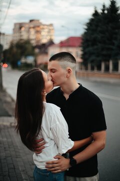Young couple kissing outdoors expressing love and connection