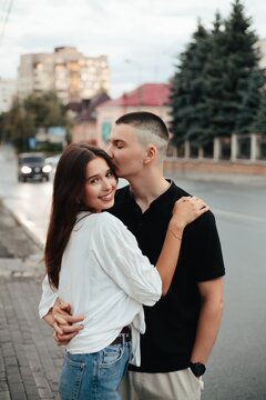 Young couple showing affection during city stroll