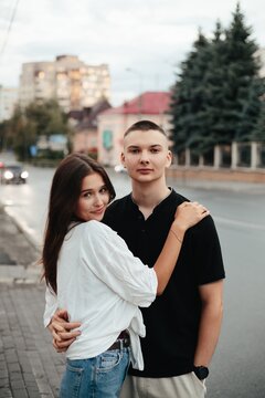 Young couple embracing outdoors in city street