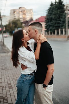Young couple kissing passionately on city street